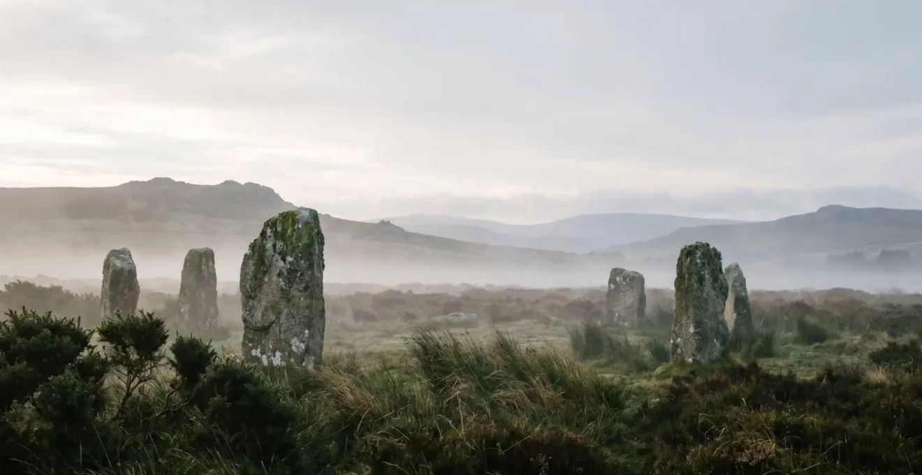 Atmospheric misty moorland with ancient standing stones and dramatic Celtic landscape under moody skies