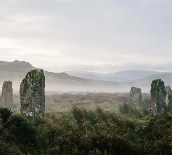 Atmospheric misty moorland with ancient standing stones and dramatic Celtic landscape under moody skies