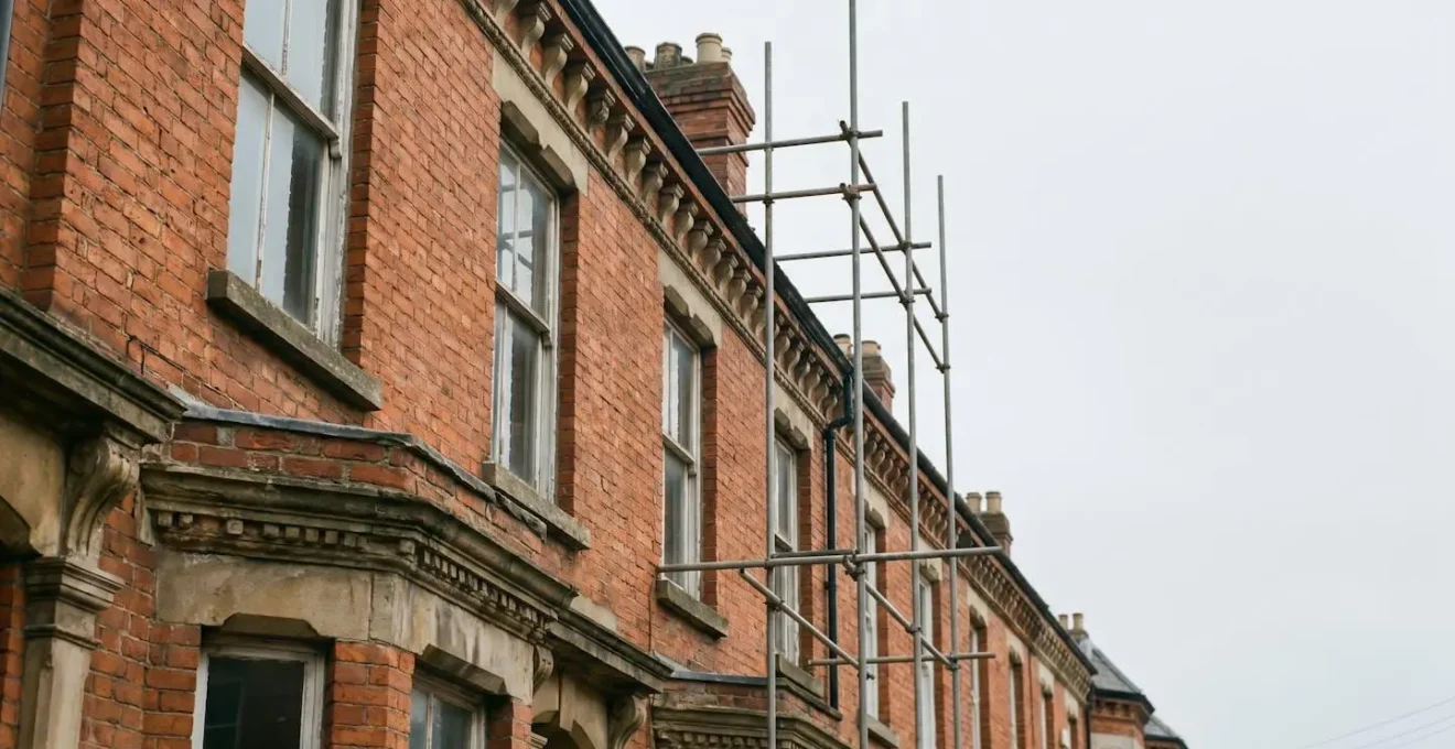 Victorian terrace house mid-renovation showing original brick facade with modern energy-efficient upgrades