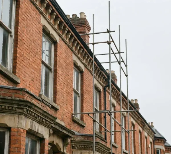 Victorian terrace house mid-renovation showing original brick facade with modern energy-efficient upgrades